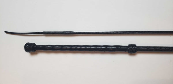 Dressage whip with leather grip and knots.